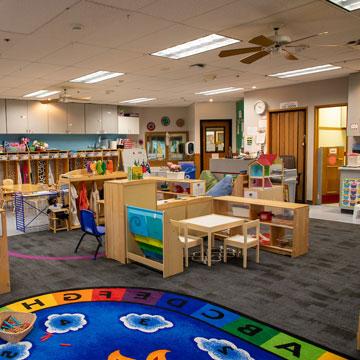 Pre-Kindergarten Classroom, showing different learning areas including block, writing, and dramatic play. 